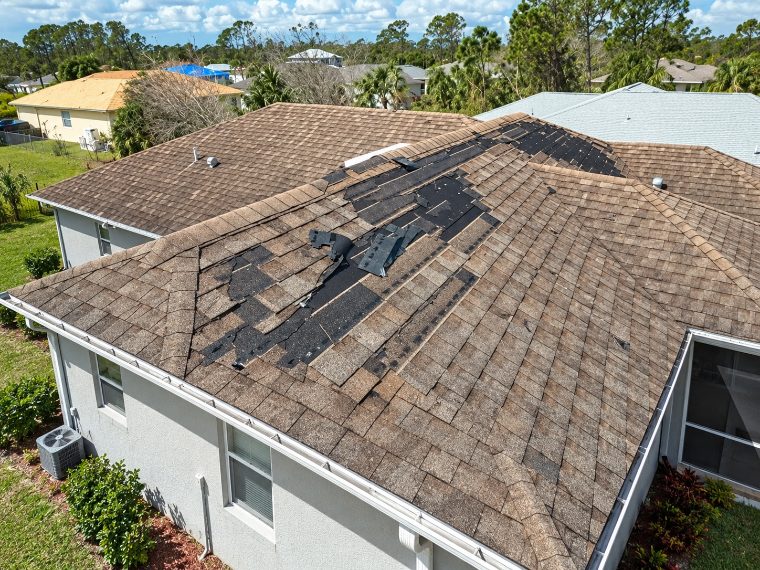 Roof with missing and lifted shingles